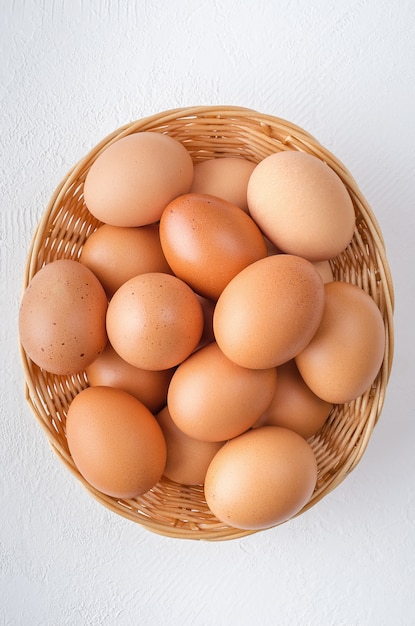 Red chicken eggs in a basket