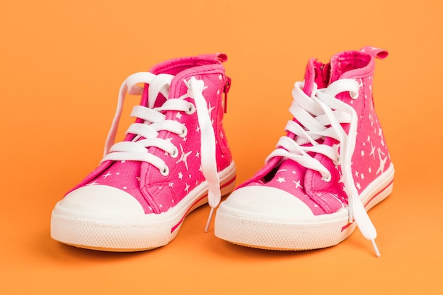 Red children's shoes On orange background