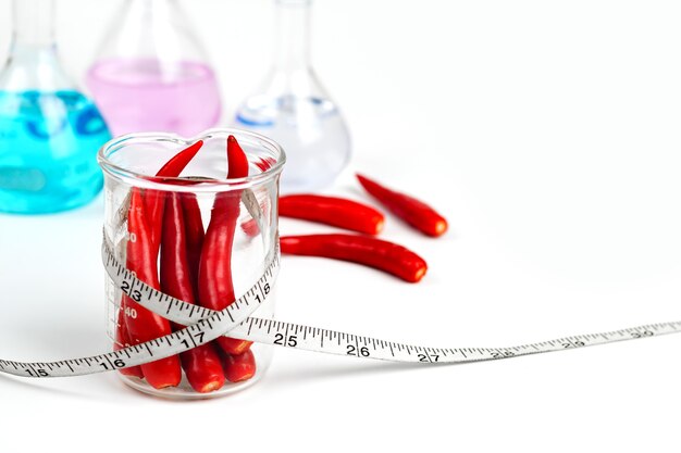 Red chili in a beaker With measuring tape With medicine 