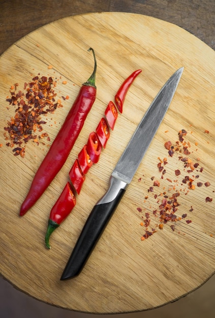 Red chili pepper cut into pieces on a black background Hot spice red chili and chili powder