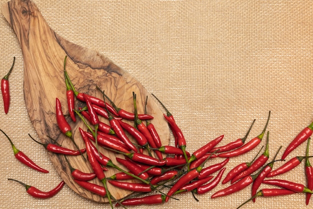 Red chili pepper on a cutting board and sackcloth