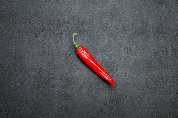 Red chili pepper on dark concrete background