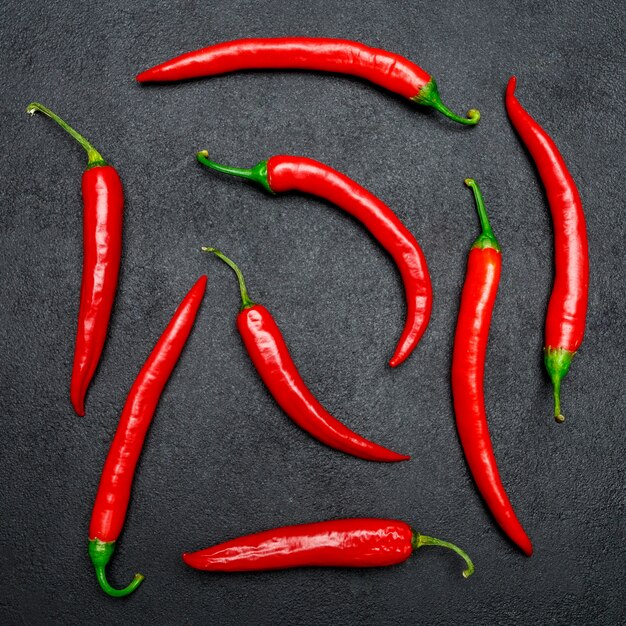 Red chili pepper on dark concrete surface