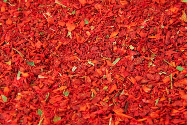 Red chili pepper flakes shot from above Mix of Spices and herbs background Various spices selection Spicy Sweet pepper red paprika full frame Empty space for text or label Turning rotation