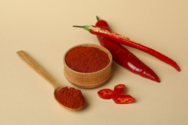 Red chili pepper and powder on beige