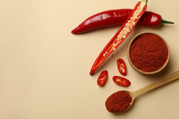 Red chili pepper and powder on beige