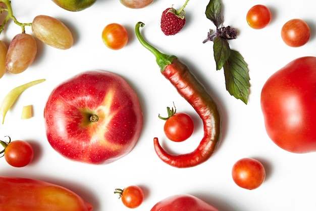 Red chili pepper and tomato on white table . Healthy food, and food for vegans