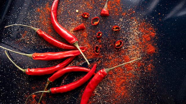 Red chili peppers on a black surface