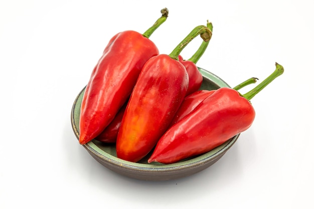 Red chili peppers in a bowl on a white background