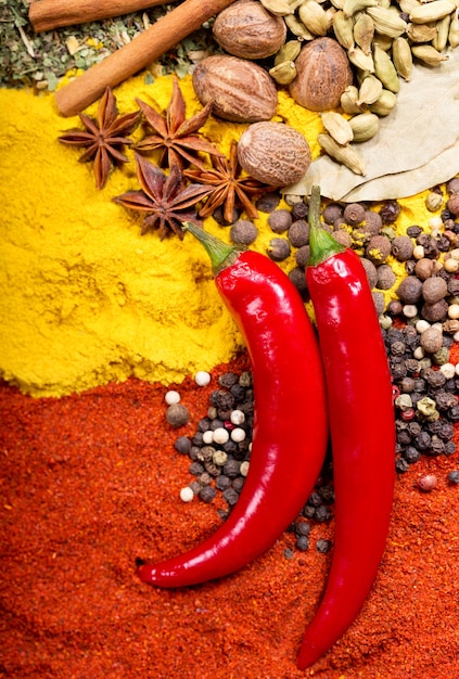Photo red chili peppers and mixed of various spices as background