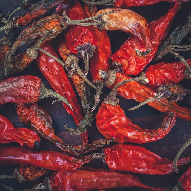 Red chili peppers on wooden board Retro toned