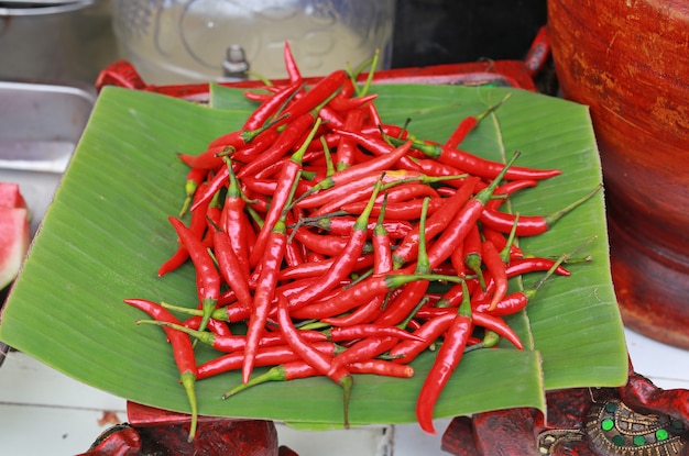 Red chillies on bamboo leaf.