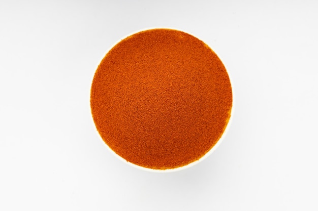 Red chilly powder Indian spicearranged in a white bowl  with white texture or background