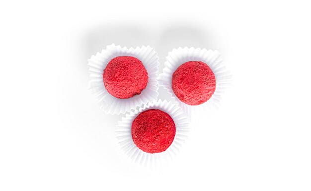 Red, chocolate candy truffles isolated. Raspberry candy.