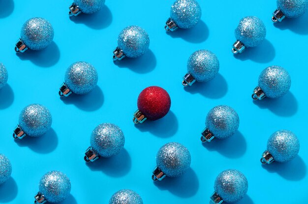 Red christmas ball among blue balls. personality concept