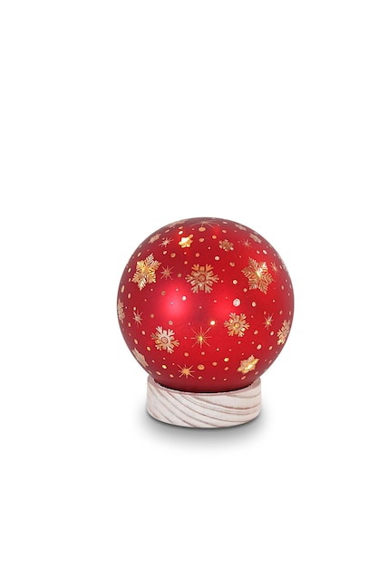 A red christmas ball with gold stars on it.