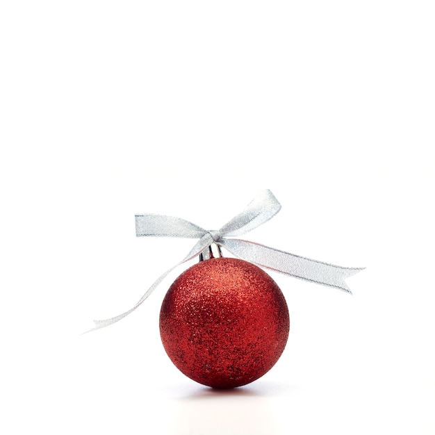 Red christmas ball with silver ribbon on white