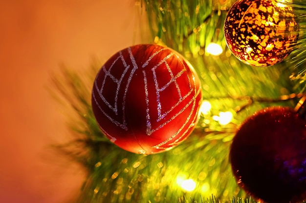 Red christmas balls on a branch of a christmas tree festive postcard christmas new year