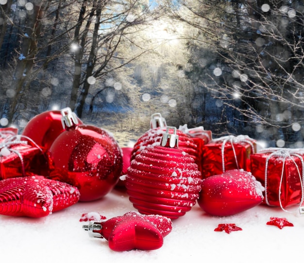 Red christmas balls in snowed forest