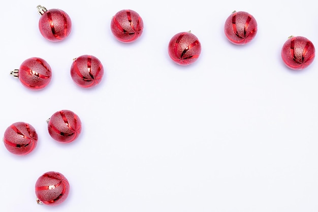 Red Christmas balls on a white background. Christmas card, invitation with place for text. Horizontal photo.