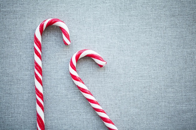 Red Christmas Candy Canes on gray background.