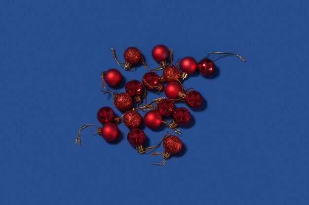 Red Christmas decoration balls on a blue background. Merry Christmas card.