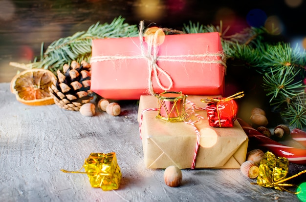 Red christmas gift box with red ribbon and fir branches