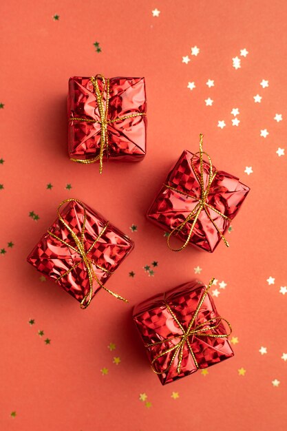 Red Christmas gifts on a red background . An article about the New year and Christmas. The choice of gifts. New Year's background