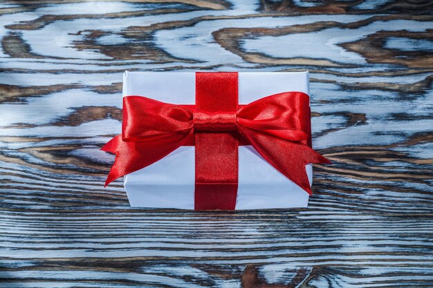 Red Christmas present box on wooden background