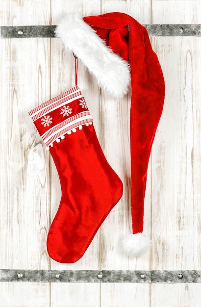 Red christmas stocking. Retro style decoration on bright wooden background