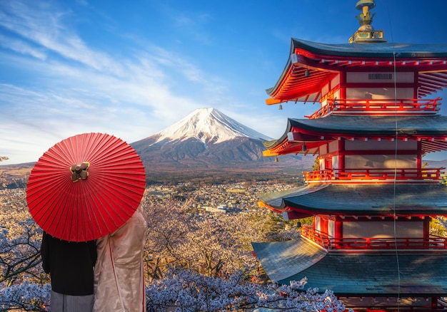 Red chureito pagoda with cherry blossom and Fujiyama mountain on the day and morning sunrise