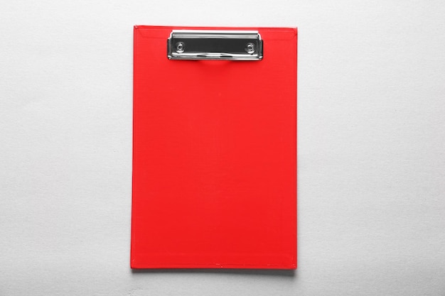 red clipboard on light background
