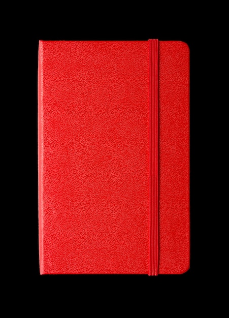 Red closed notebook isolated on black