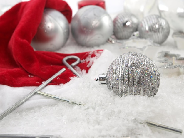 A red cloth is next to a silver christmas tree.