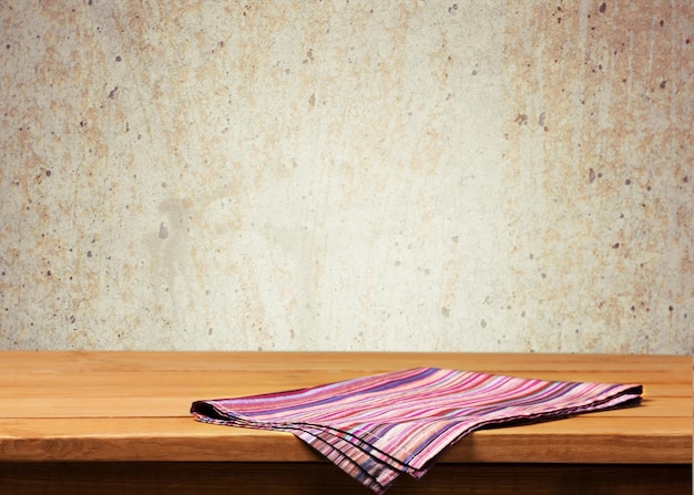 Red cloth napkin on wooden background