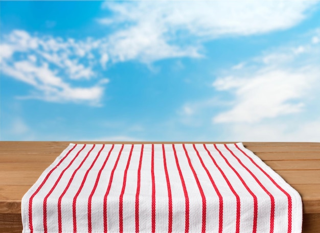 Red cloth napkin on wooden background