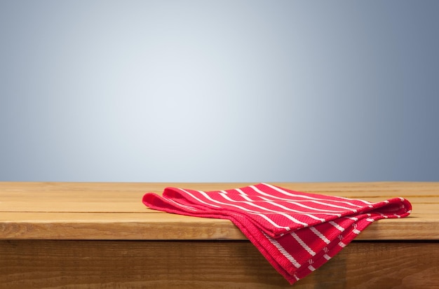 Red cloth napkin on wooden table