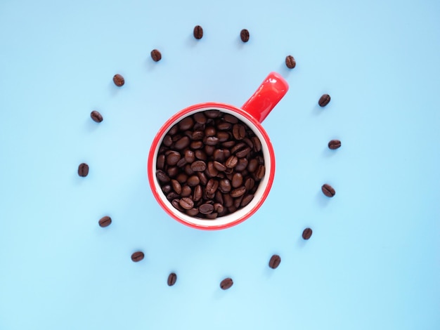 red coffee cup on background with Coffee beans