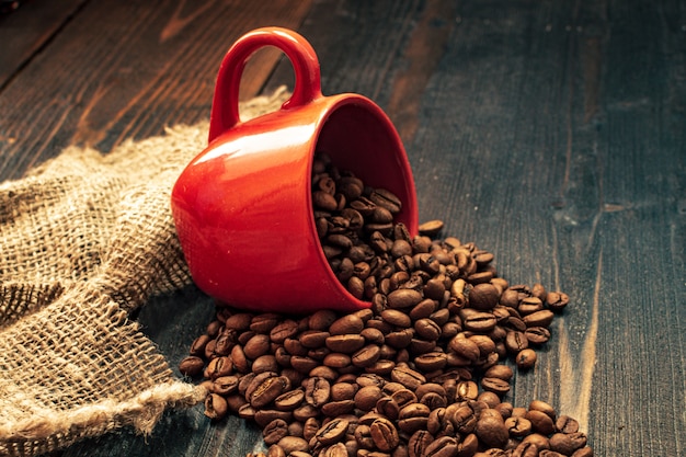 Red coffee cup on wooden desk, coffee mood