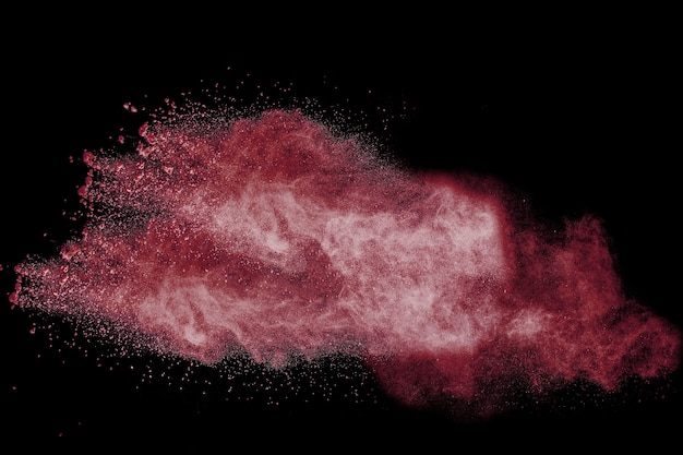 red color powder explosion on black background.