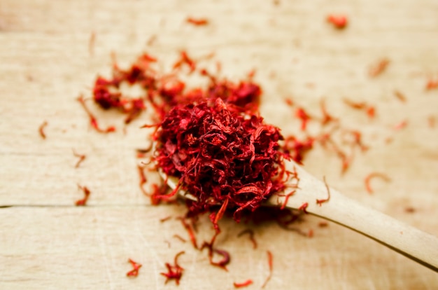 Red color Saffron in wooden spoon.Close up view of exotic spice