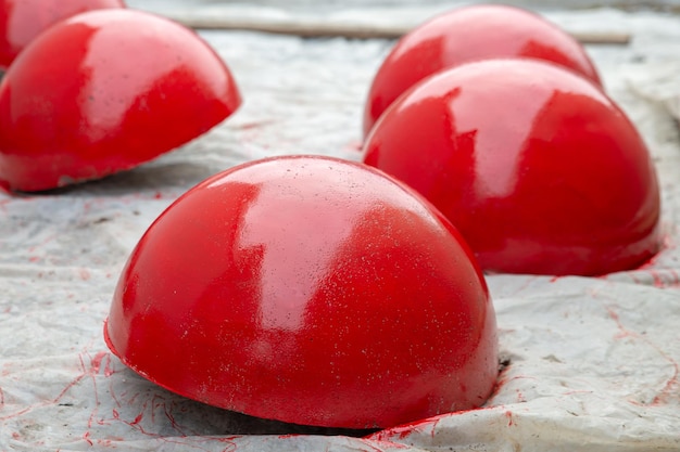 Red concrete parking barriers in the form of hemispheres