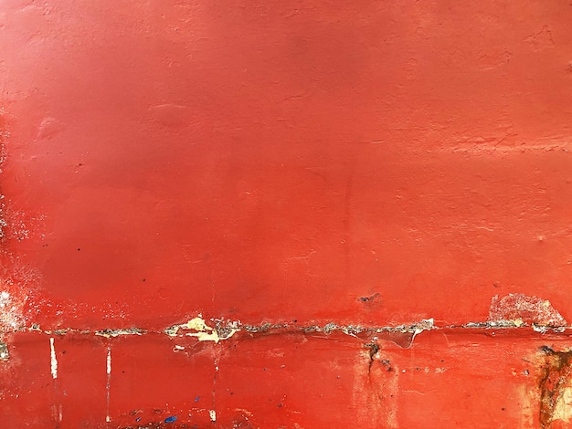 Red concrete wall with weathered surface