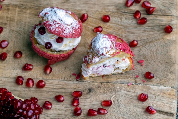 Red cranberryflavored cake with cranberry berries and creamy milk filling of cottage cheese with pomegranate seeds