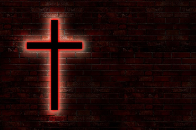 A red cross on a brick wall with the word jesus on it