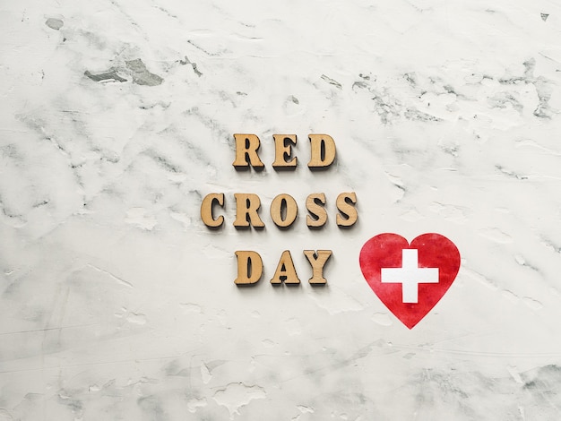 Red Cross Day. Beautiful greeting card. Closeup, view from above.