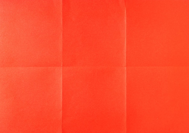 Red crumpled unfolded paper sheet texture background paper folded in six full frame