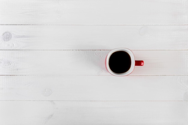 Red cup coffee on white wood background