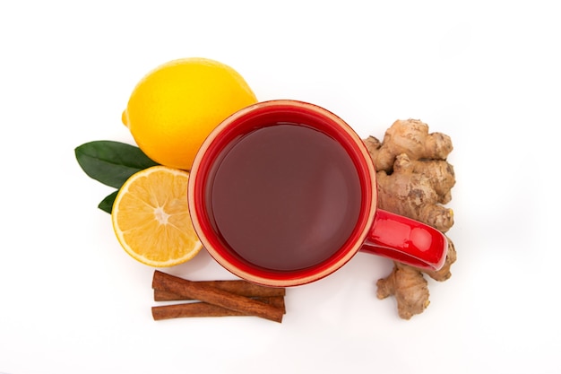 Red Cup of hot black or green tea with lemon and ginger on a white background. Ingredients against influenza and viruses. Natural medicine.