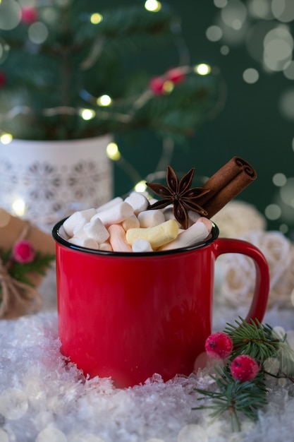 Red cup of hot spicy Christmas drink and New Year  decorations.